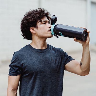 Woman drinking water after a workout session